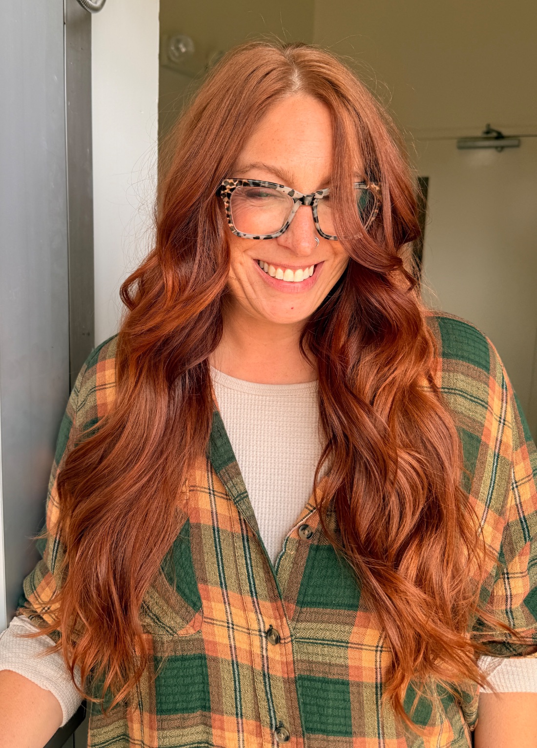 Bright copper curls worn long.